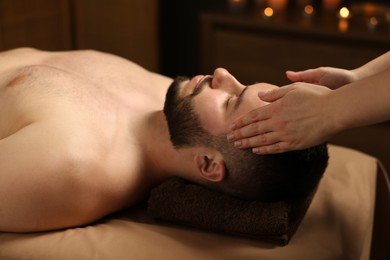 Photo of Man receiving relaxing massage in spa salon