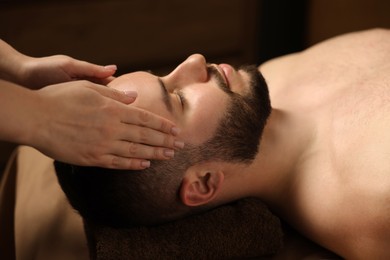 Photo of Man receiving relaxing massage in spa salon