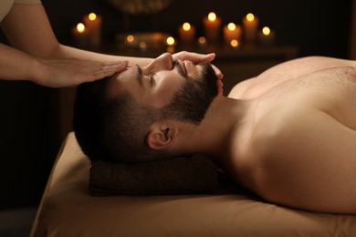 Photo of Man receiving relaxing massage in spa salon