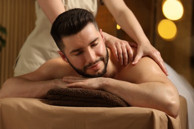 Photo of Man receiving relaxing massage in spa salon
