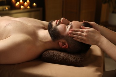 Photo of Man receiving relaxing massage in spa salon