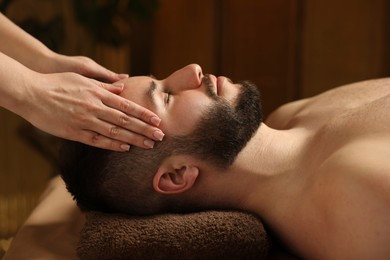 Photo of Man receiving relaxing massage in spa salon