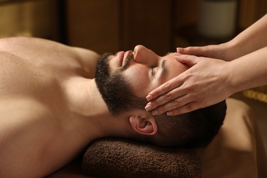 Photo of Man receiving relaxing massage in spa salon