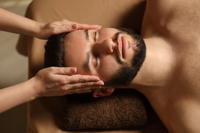 Photo of Man receiving relaxing massage in spa salon, above view