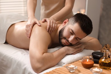 Photo of Man receiving relaxing massage in spa salon