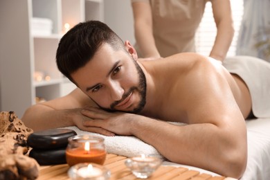Photo of Man receiving relaxing massage in spa salon