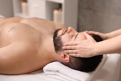 Photo of Man receiving relaxing massage in spa salon