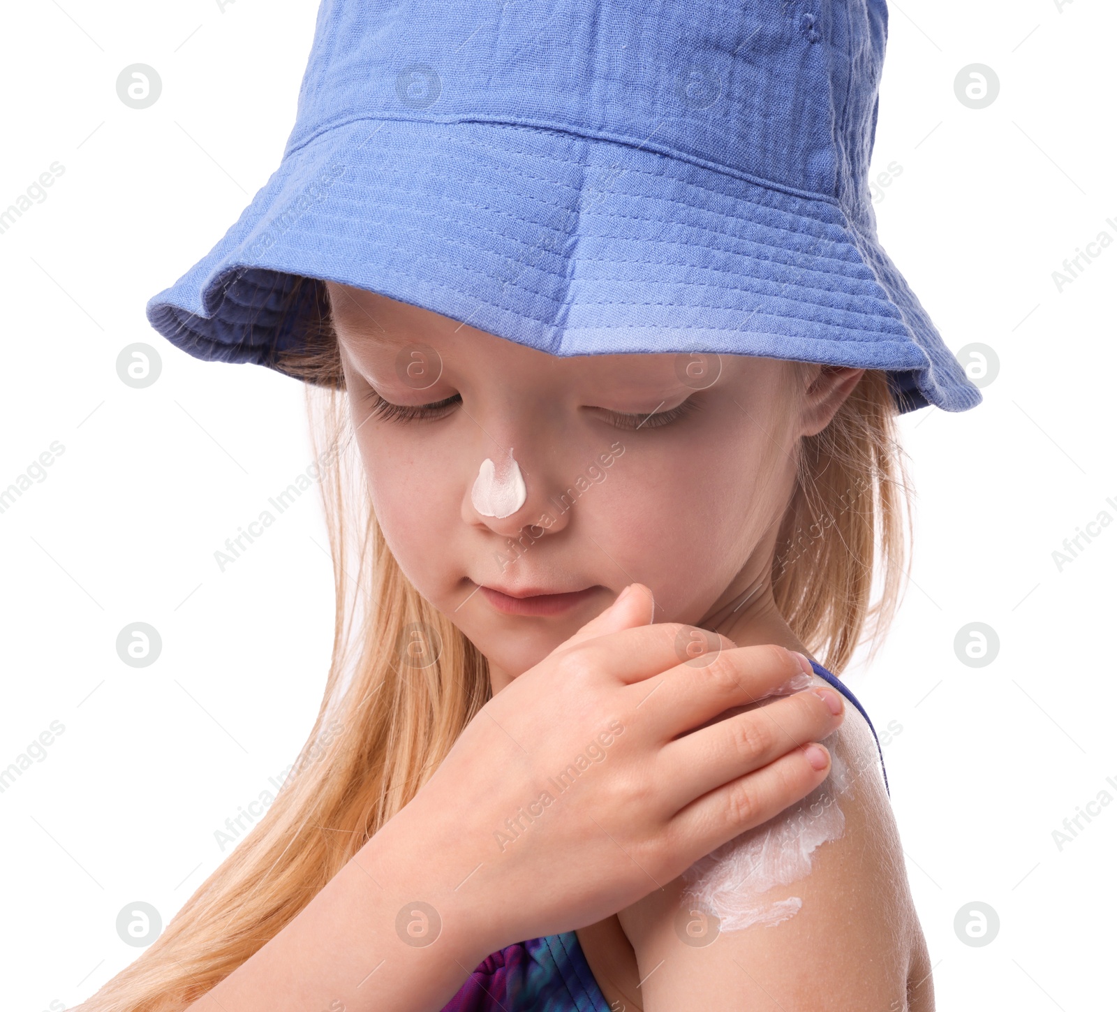 Cute little girl applying sun protection cream onto her shoulder against white background Photo of Cute little girl applying sun protection cream onto her shoulder against white background