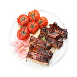 Photo of Delicious pork ribs, sun dried tomatoes and onion isolated on white, top view