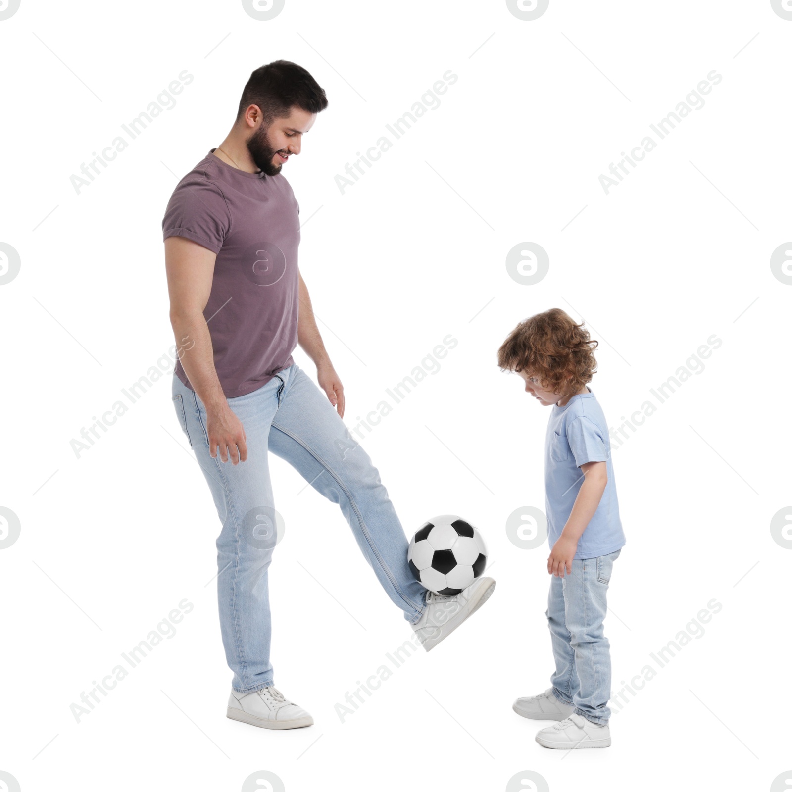 Happy father and his son playing football on white background Photo of Happy father and his son playing football on white background
