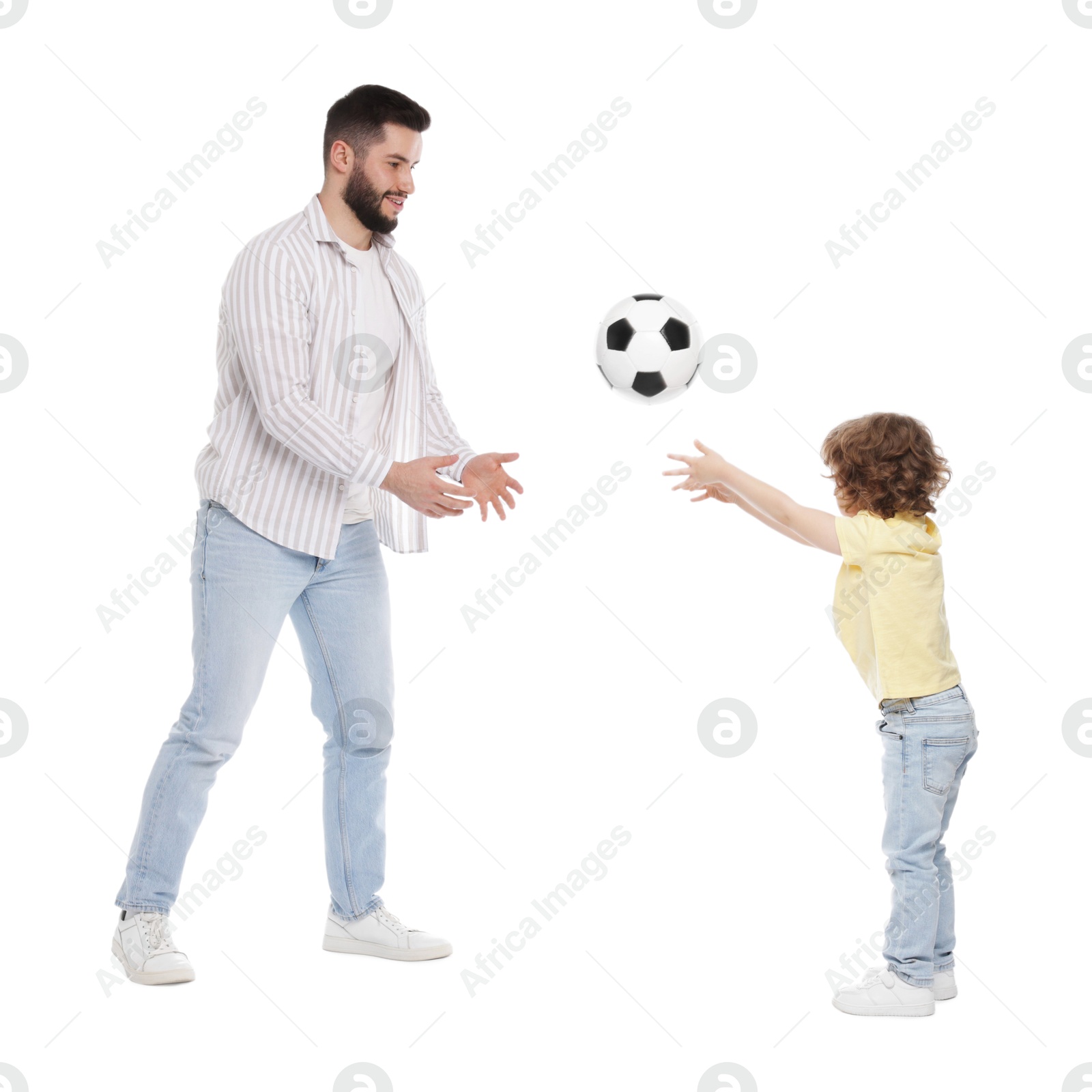 Happy father and his son playing football on white background Photo of Happy father and his son playing football on white background