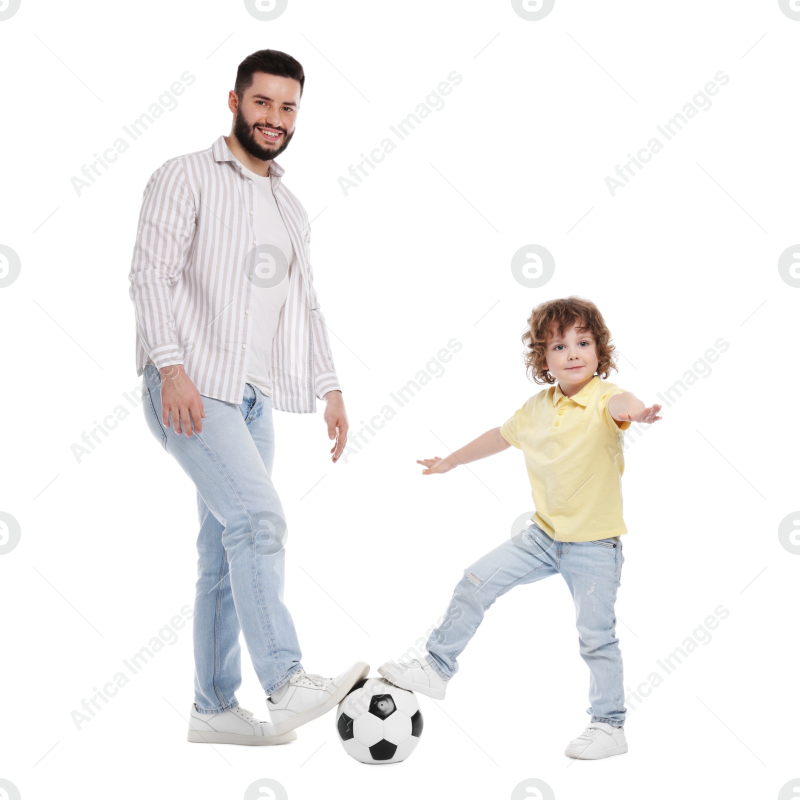 Happy father and his son playing football on white background Photo of Happy father and his son playing football on white background