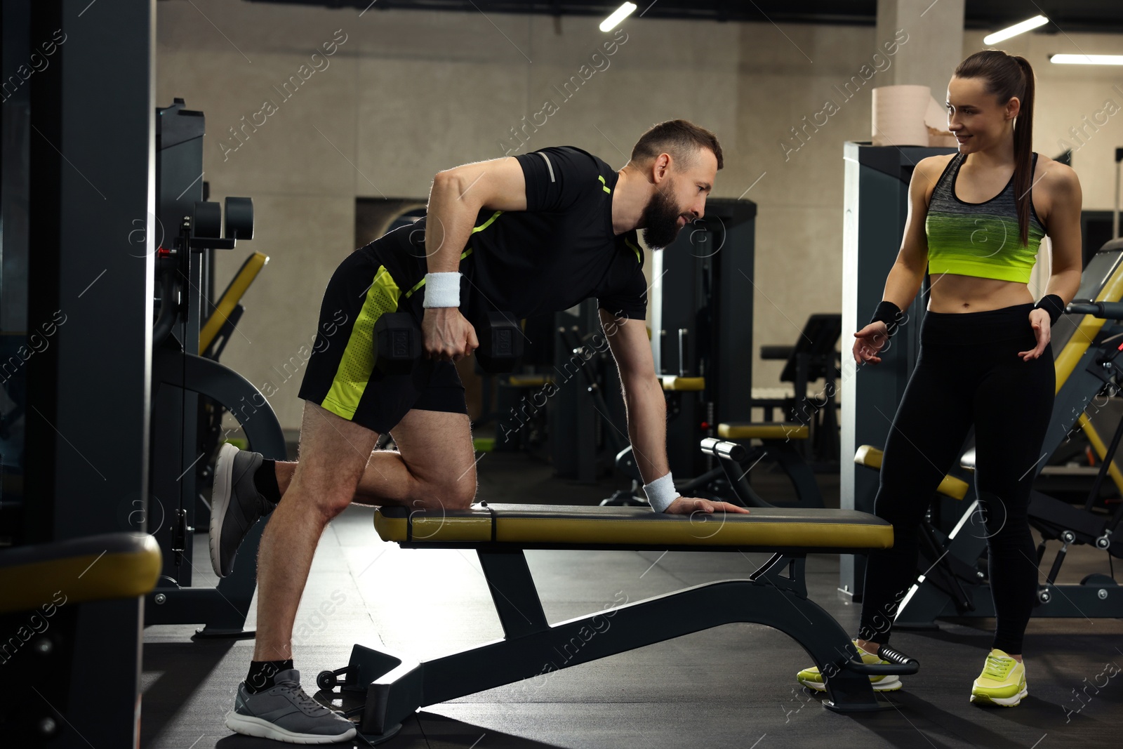 Athletic man and woman training in gym Photo of Athletic man and woman training in gym