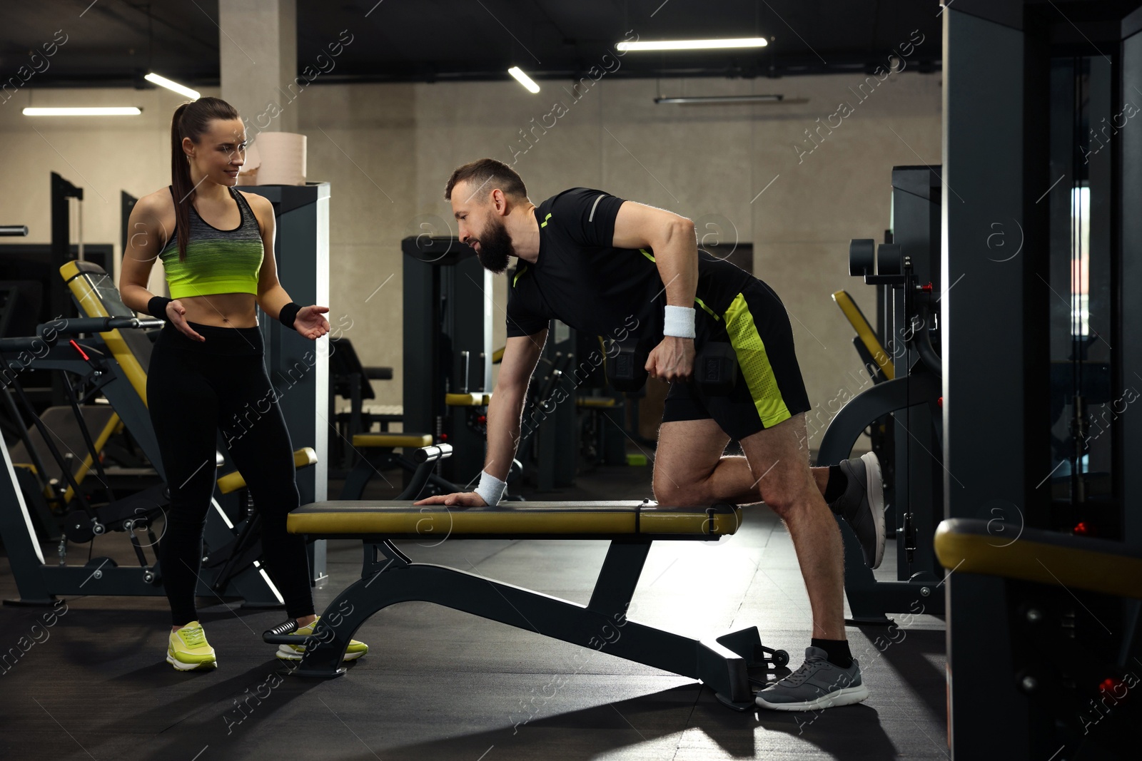 Athletic man and woman training in gym Photo of Athletic man and woman training in gym