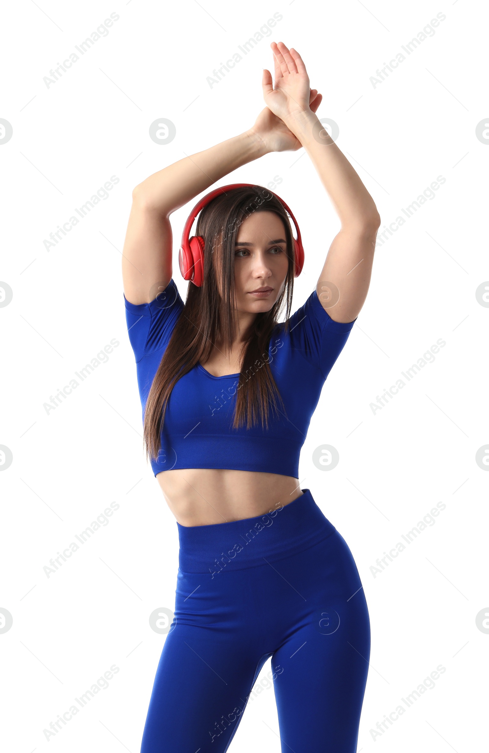 Woman in sportswear with headphones posing on white background Photo of Woman in sportswear with headphones posing on white background