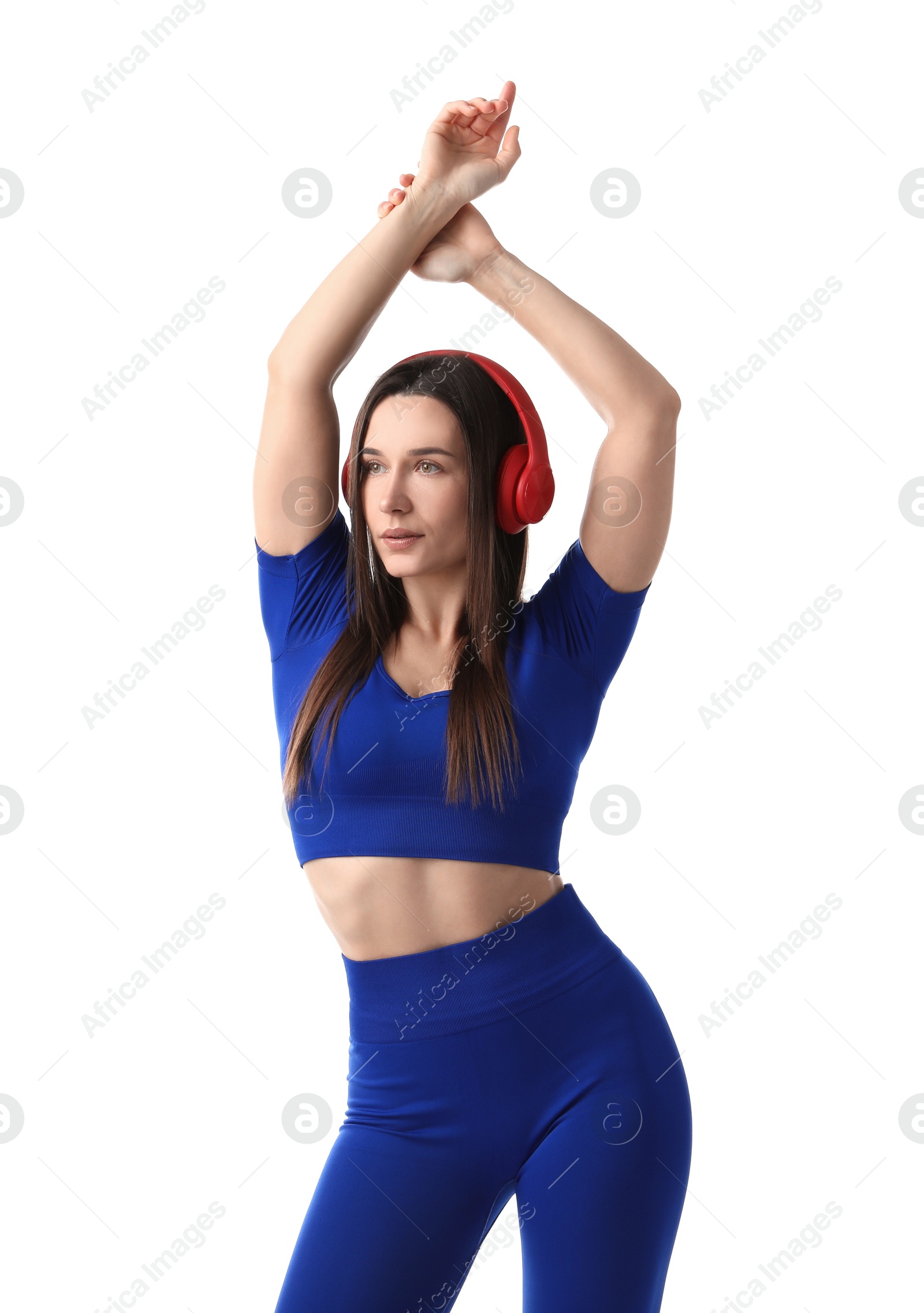 Woman in sportswear with headphones posing on white background Photo of Woman in sportswear with headphones posing on white background