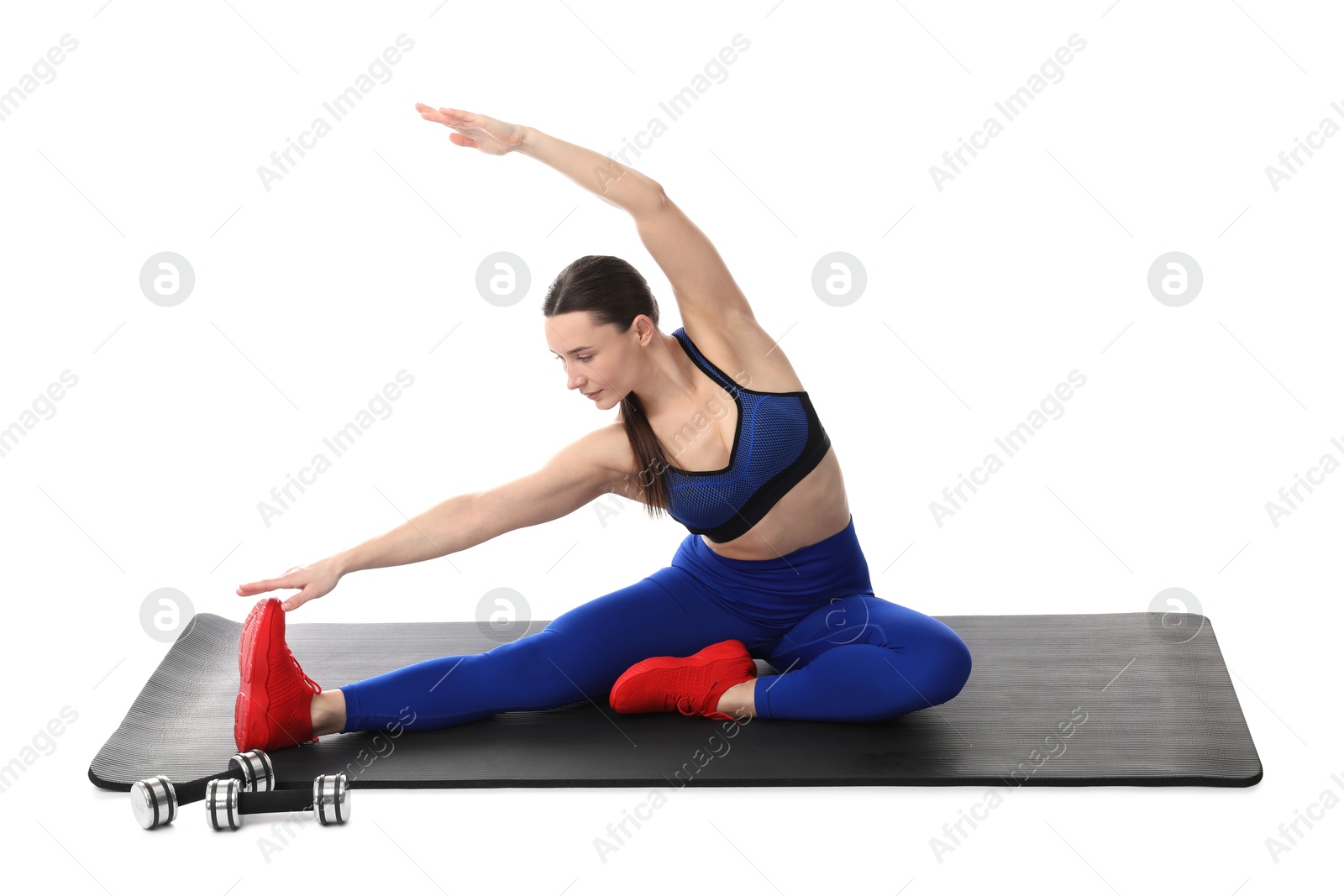 Woman in sportswear exercising on white background Photo of Woman in sportswear exercising on white background