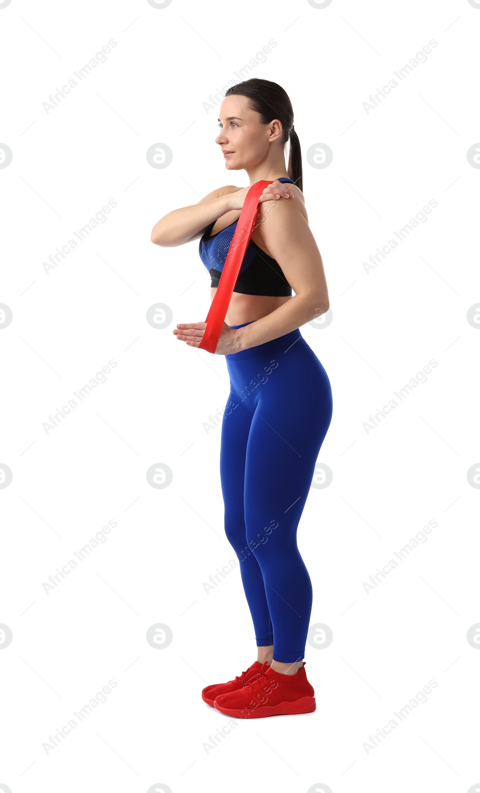 Photo of Woman in sportswear exercising with elastic band on white background