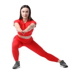 Photo of Woman in sportswear exercising on white background