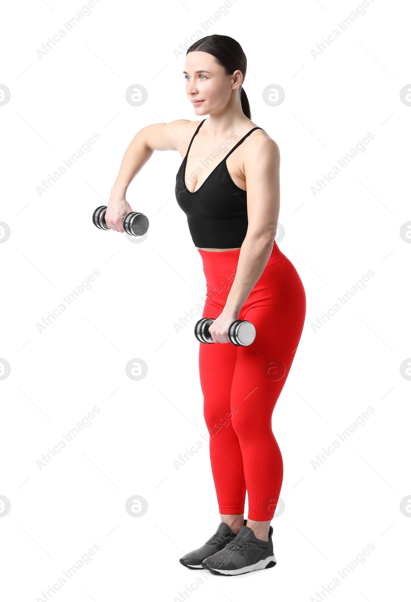 Woman in sportswear exercising with dumbbells on white background Photo of Woman in sportswear exercising with dumbbells on white background