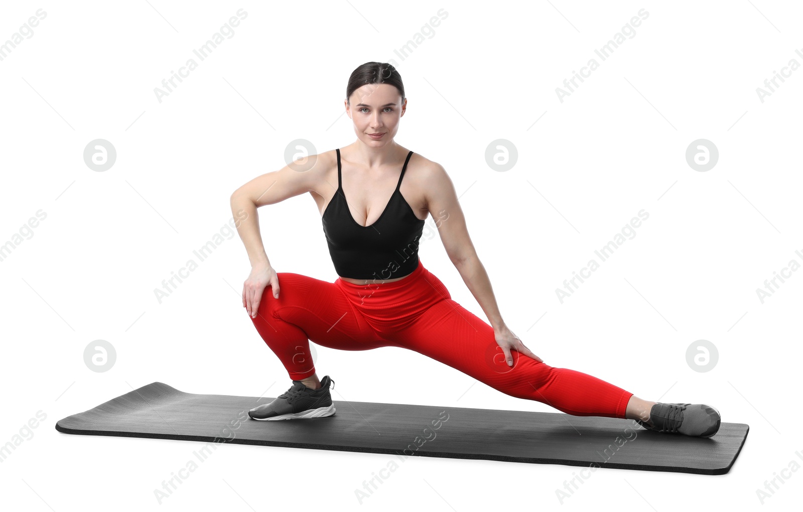 Woman in sportswear exercising on white background Photo of Woman in sportswear exercising on white background