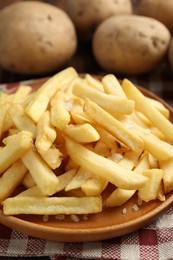 Photo of Tasty french fries served on table, closeup