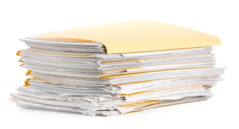 Photo of Stack of file folders with papers isolated on white