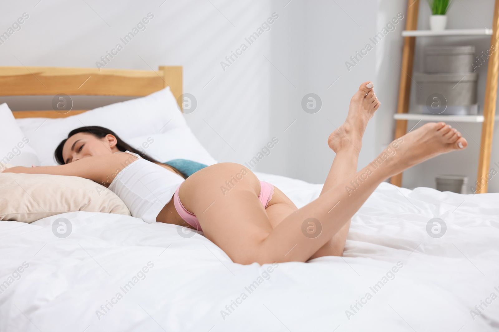 Woman in beautiful underwear lying on bed Photo of Woman in beautiful underwear lying on bed