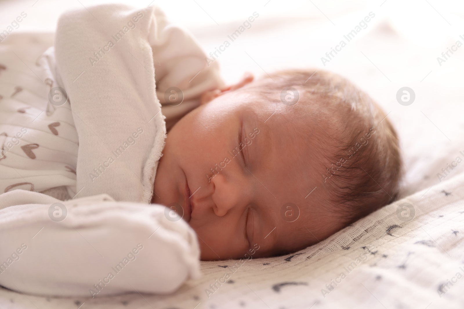 Bedtime. Cute little baby sleeping in bed indoors Photo of Bedtime. Cute little baby sleeping in bed indoors