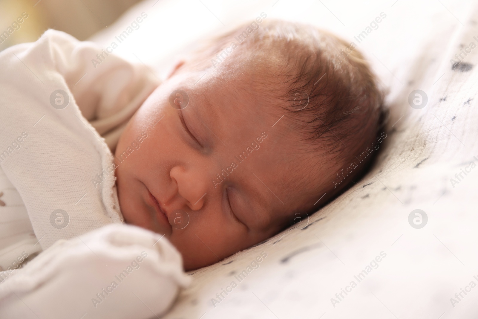 Bedtime. Cute little baby sleeping in bed indoors Photo of Bedtime. Cute little baby sleeping in bed indoors