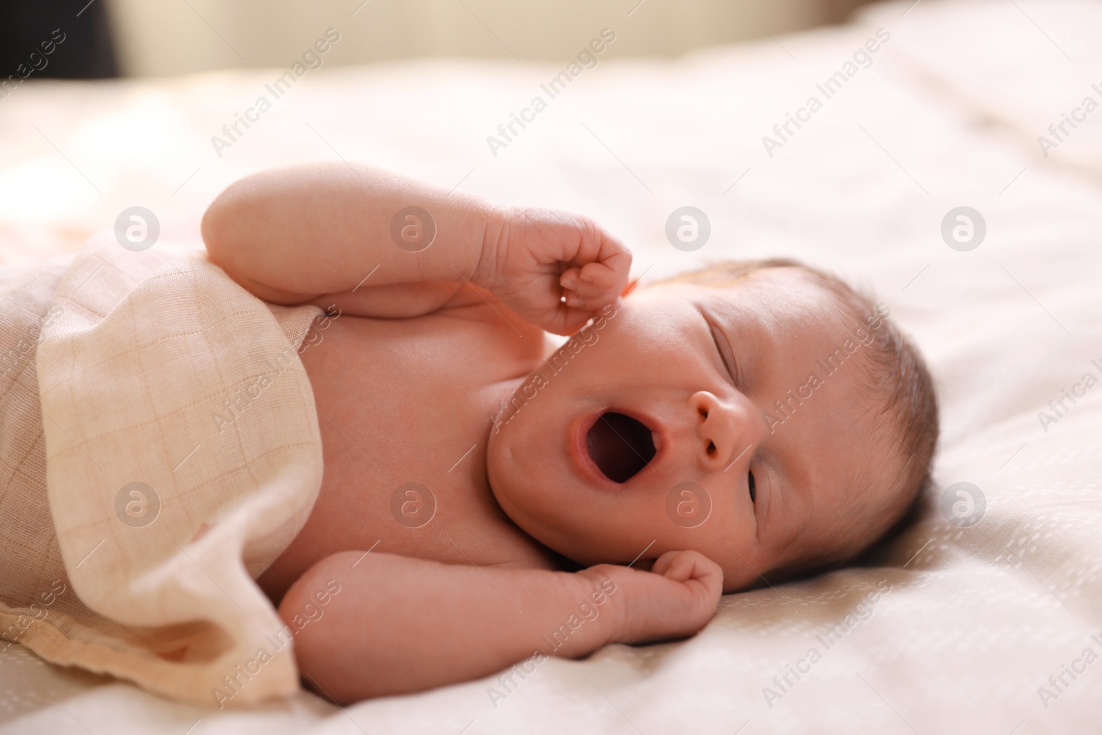 Bedtime. Cute little baby yawning in bed indoors Photo of Bedtime. Cute little baby yawning in bed indoors
