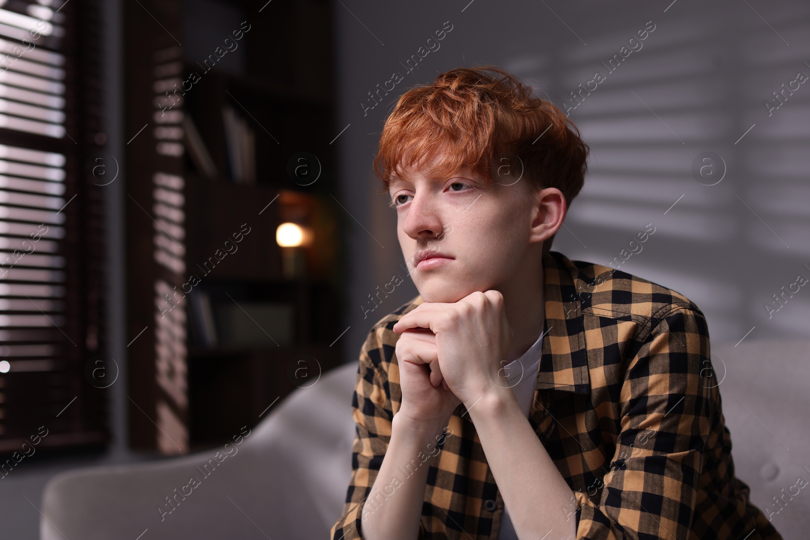 Teen problems. Depressed teenage boy at home, space for text Photo of Teen problems. Depressed teenage boy at home, space for text