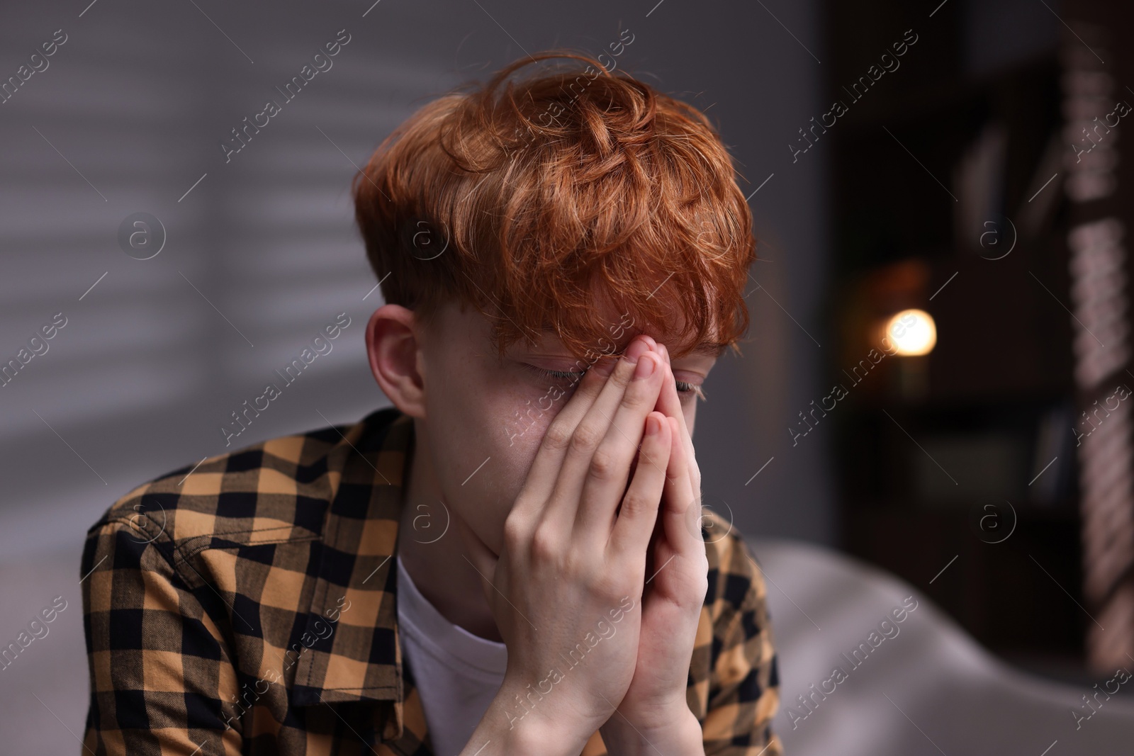 Teen problems. Depressed teenage boy at home Photo of Teen problems. Depressed teenage boy at home
