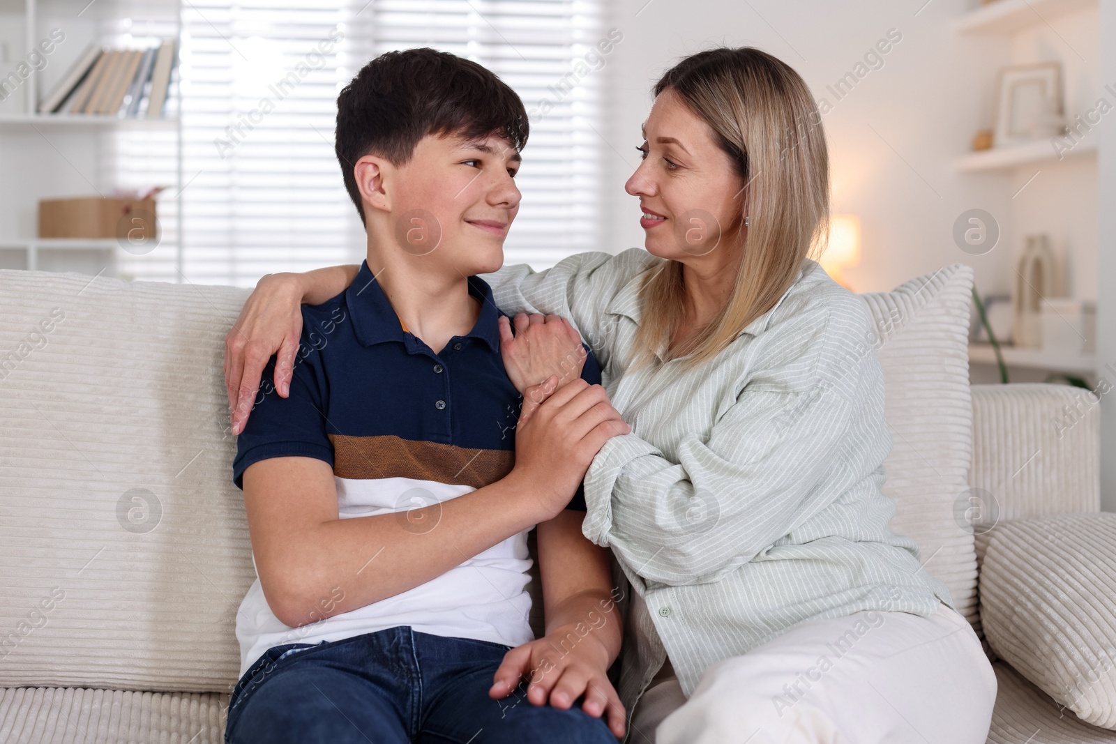 Mother and her son on sofa at home Photo of Mother and her son on sofa at home