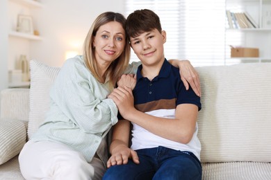 Photo of Mother and her son on sofa at home