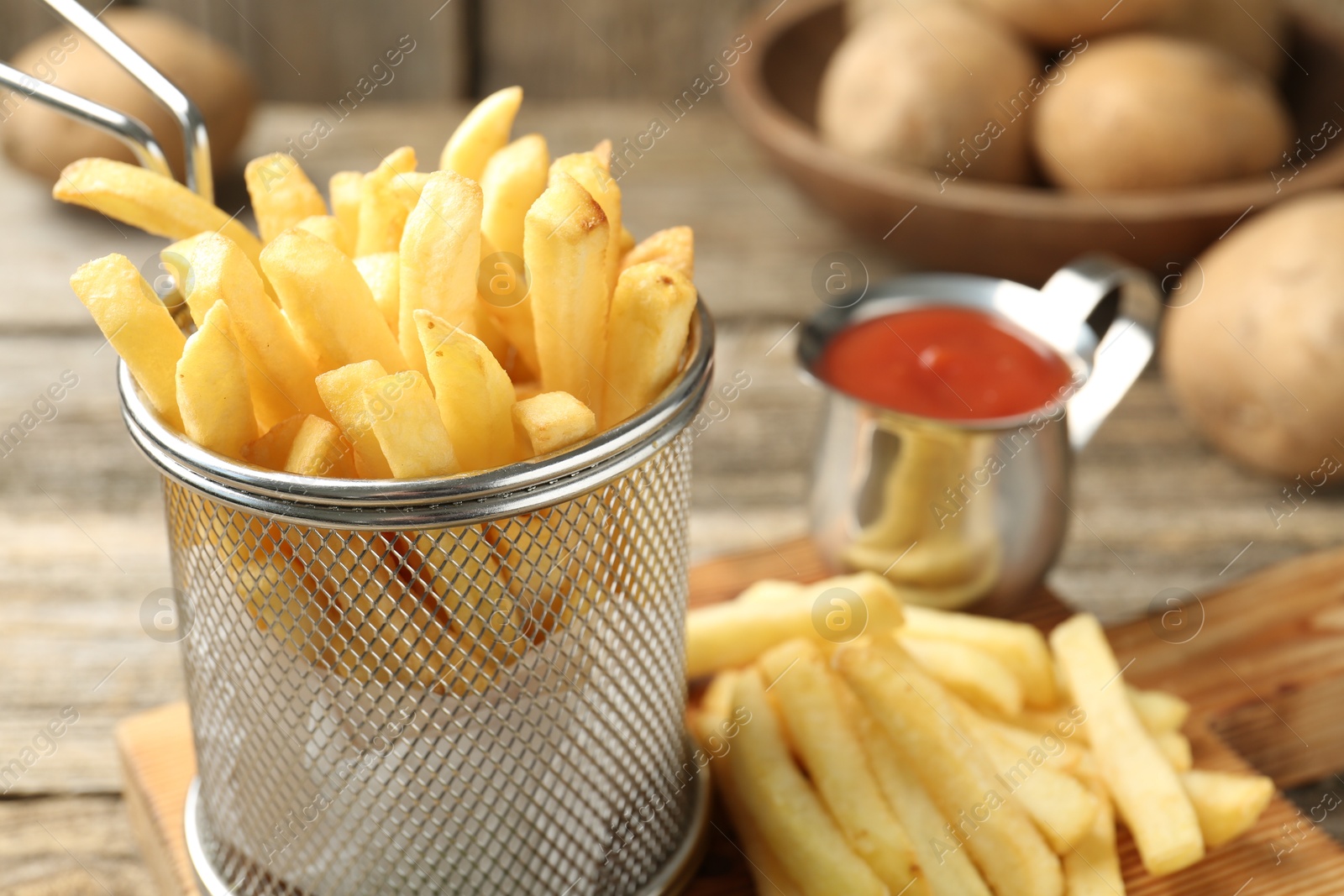 Tasty french fries served with ketchup on wooden table, closeup Photo of Tasty french fries served with ketchup on wooden table, closeup