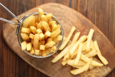 Photo of Tasty french fried served on wooden table, top view