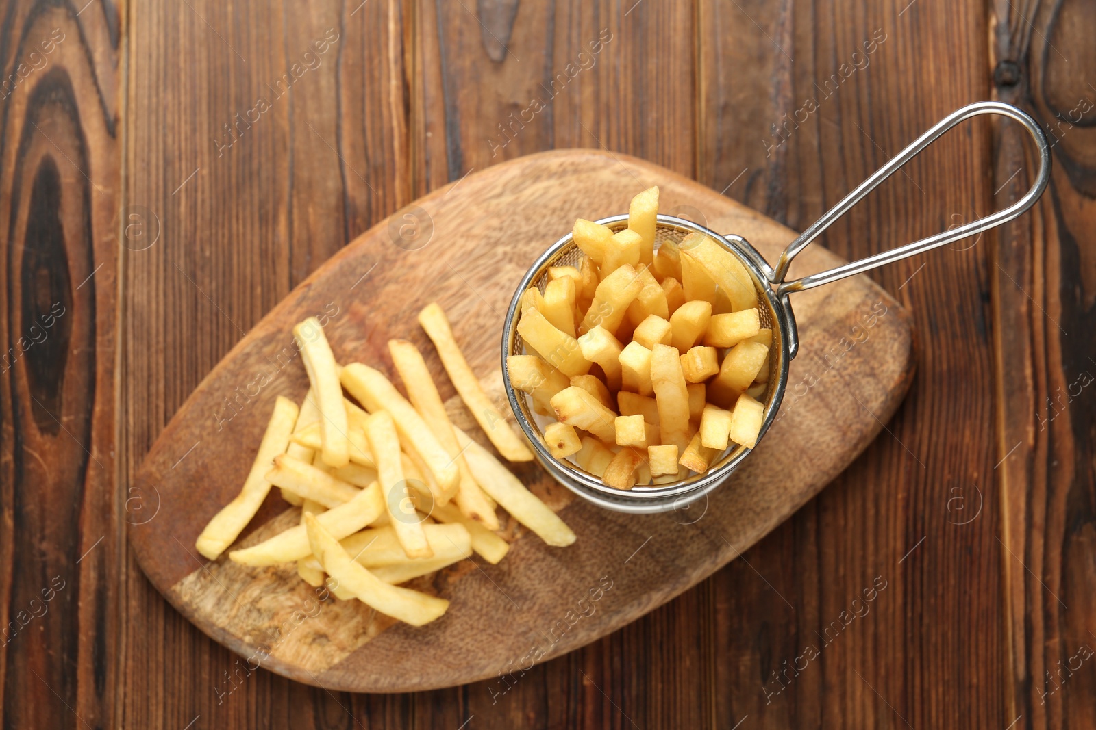 Photo of Tasty french fried served on wooden table, top view