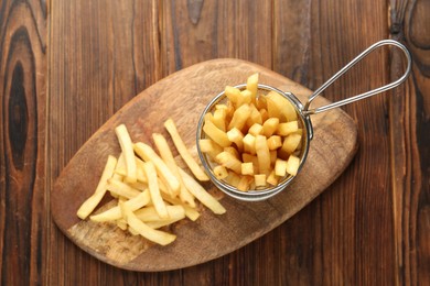 Photo of Tasty french fried served on wooden table, top view