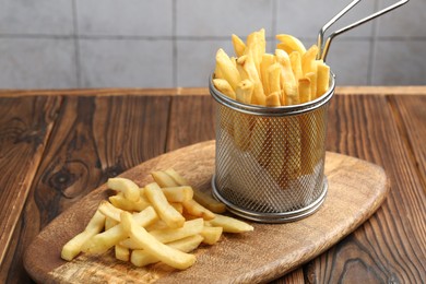 Photo of Tasty french fried served on wooden table, closeup