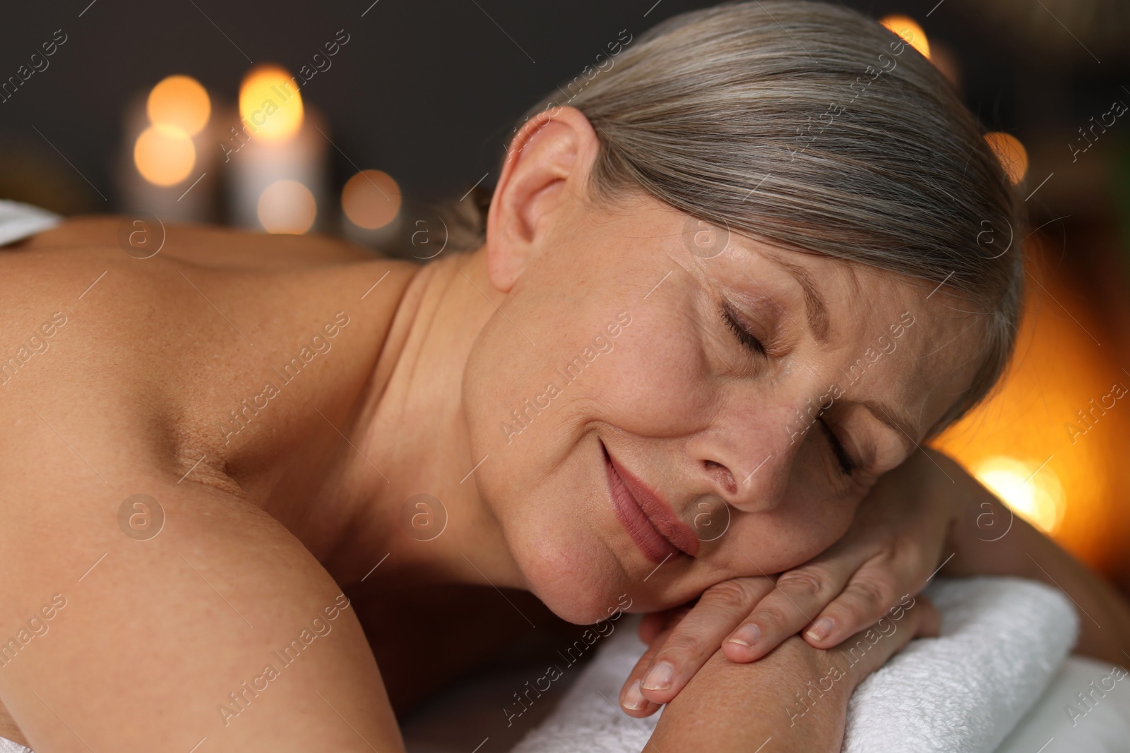 Senior woman relaxing on massage couch in spa salon, closeup Photo of Senior woman relaxing on massage couch in spa salon, closeup