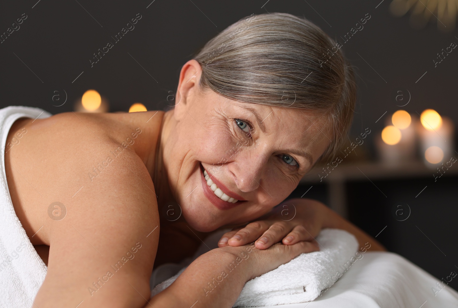 Senior woman relaxing on massage couch in spa salon Photo of Senior woman relaxing on massage couch in spa salon