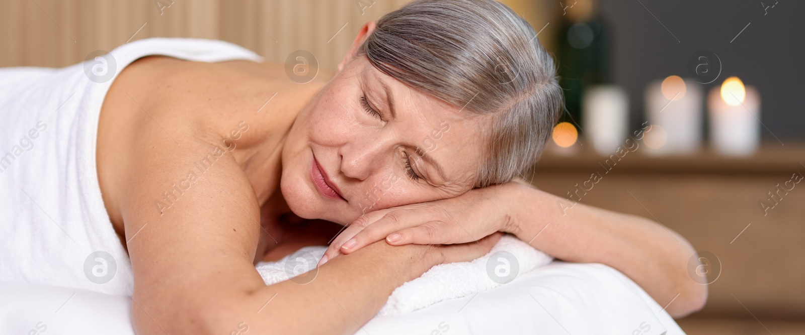 Senior woman relaxing on massage couch in spa salon Photo of Senior woman relaxing on massage couch in spa salon