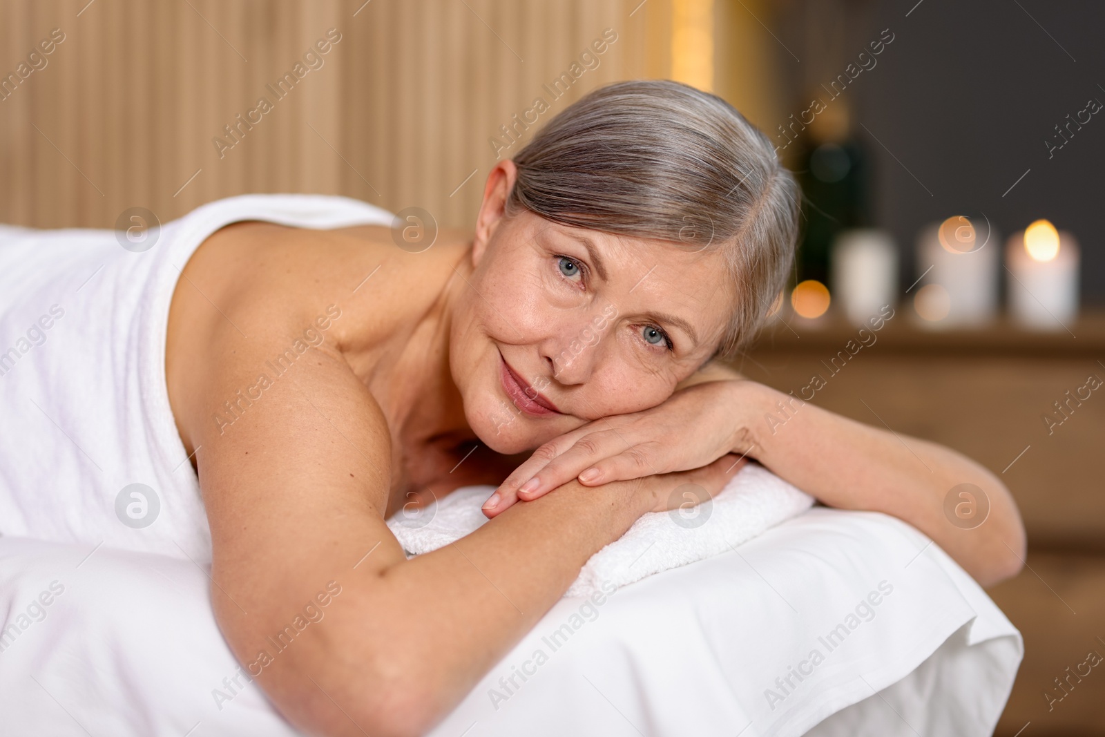 Senior woman relaxing on massage couch in spa salon Photo of Senior woman relaxing on massage couch in spa salon