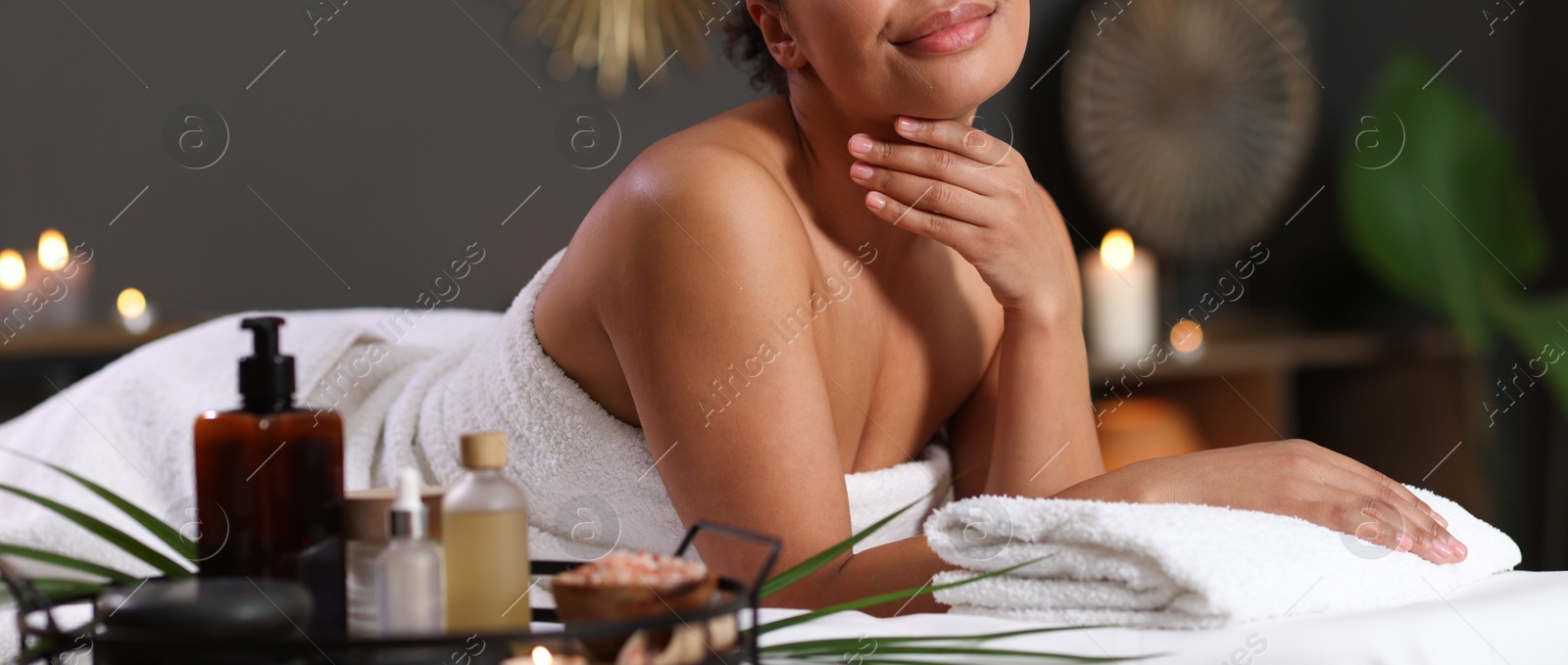 Photo of Woman relaxing on massage couch in spa salon, closeup