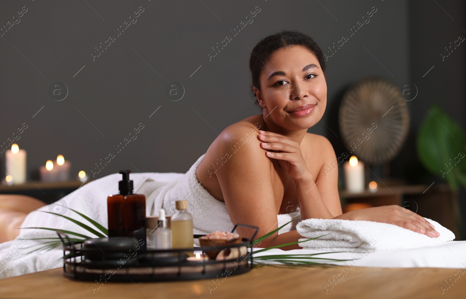 Beautiful woman relaxing on massage couch in spa salon Photo of Beautiful woman relaxing on massage couch in spa salon