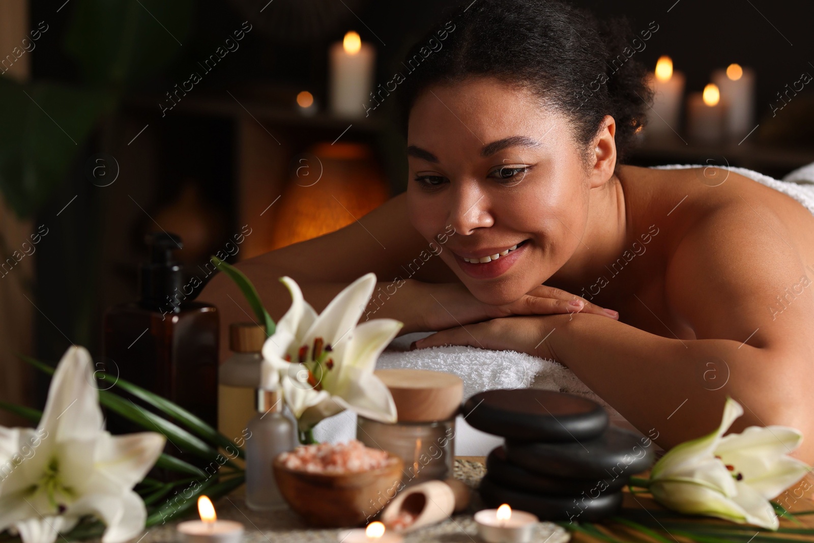 Photo of Beautiful woman relaxing on massage couch in spa salon