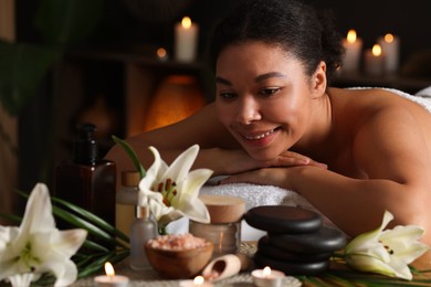 Photo of Beautiful woman relaxing on massage couch in spa salon