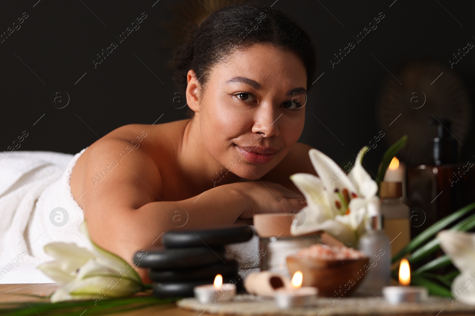 Beautiful woman relaxing on massage couch in spa salon Photo of Beautiful woman relaxing on massage couch in spa salon