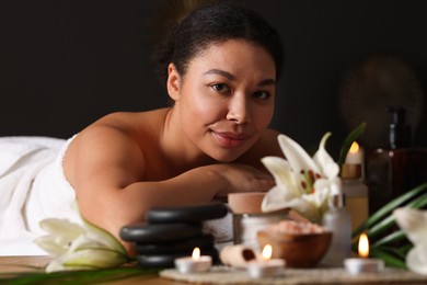 Photo of Beautiful woman relaxing on massage couch in spa salon